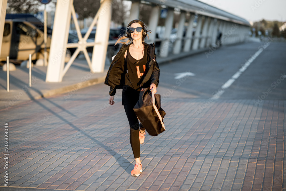 Sports woman walking on the street after the training