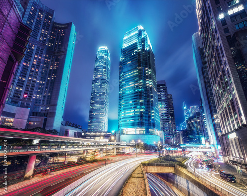 Nighttime cityscape of Hong Kong with skyscrapers and highways. Scenic travel background.