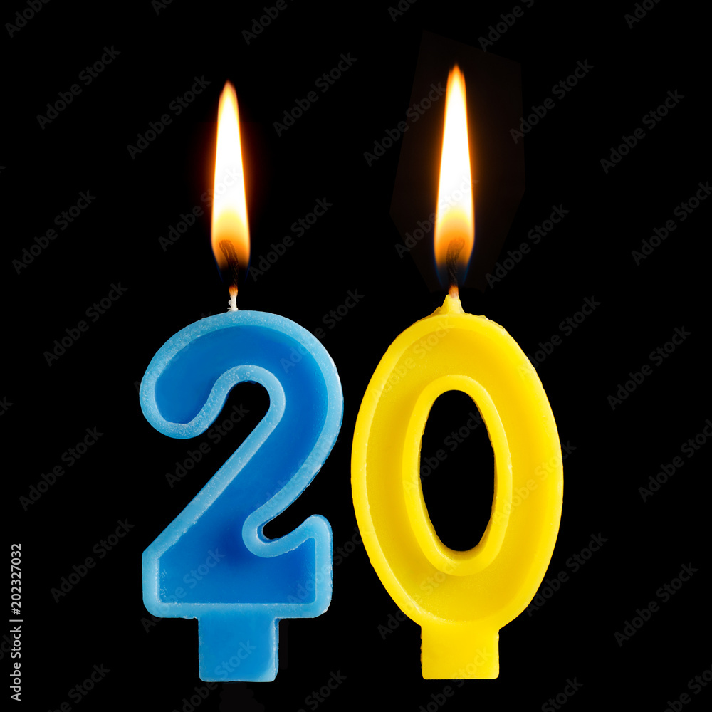Burning birthday candles in the form of 20 twenty figures for cake isolated on black background. The concept of celebrating a birthday, anniversary, important date, holiday Burning birthday candles in the form of 20 twenty figures for cake isolated on black background. The concept of celebrating a birthday, anniversary, important date, holiday