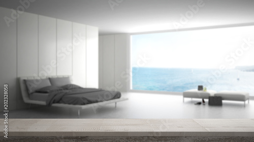 Wooden vintage table top or shelf closeup  zen mood  over blurred minimalist bedroom with big window on sea panorama  white architecture interior design