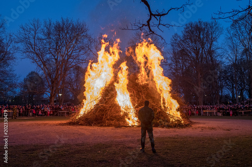 Traditional Swedish celebration of spring at Walpurgis night with bonfire and music at Folkparken in Norrkoping  photo