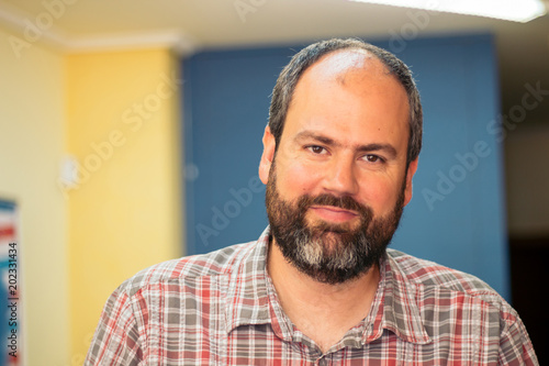 Fotografie Portrait of big bearded man inside barbershop.