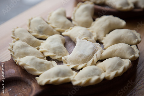 Traditional Ukrainian dumplings Varenyky being hand made by an old woman