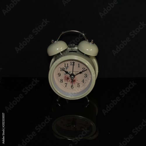 twin bell clock on the black background