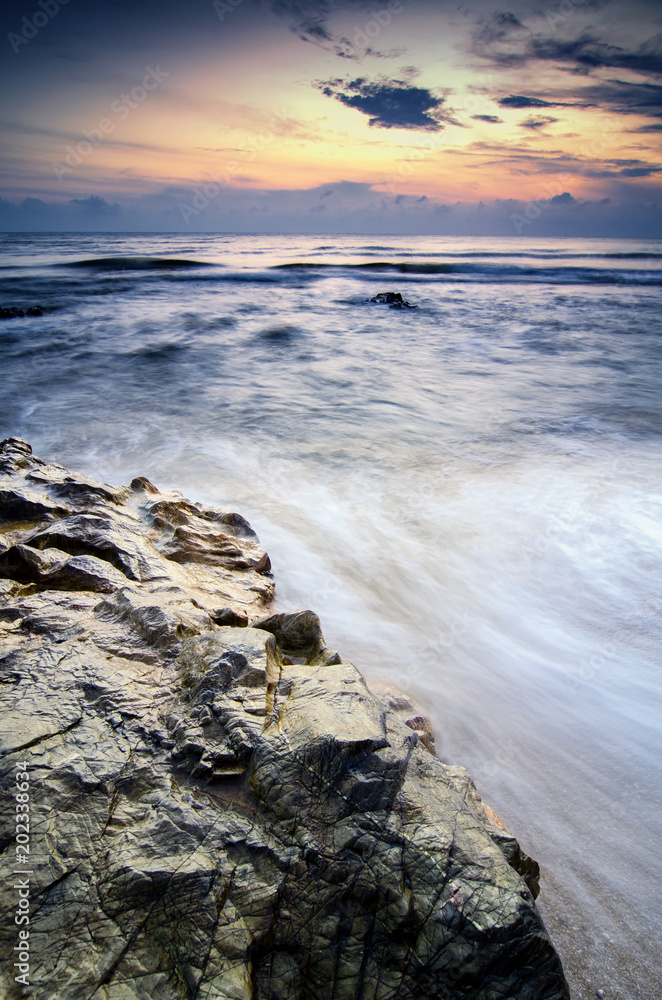 Travel and leisure concept, beautiful sea view scenery over stunning sunrise background.sunlight beam and soft wave hitting sandy beach Travel and leisure concept, beautiful sea view scenery over stunning sunrise background.sunlight beam and soft wave hitting sandy beach