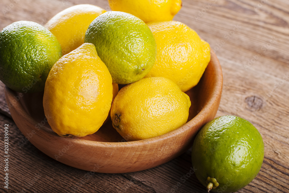 Lemons in a bowl on a wooden table