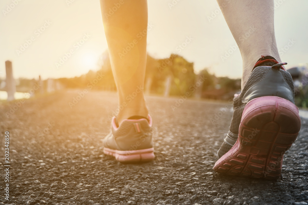 Sports background. Runner feet running on road closeup on shoe. when exercising or running jogging outdoors. Sports background. Runner feet running on road closeup on shoe. when exercising or running jogging outdoors.