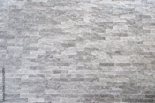 A gray stone wall surface with cement a background texture.