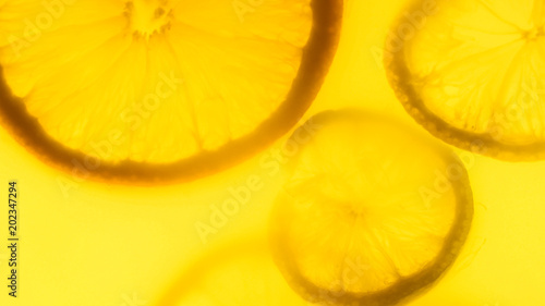 Closeup image of silhouettes of freshly cut otanges and lemons