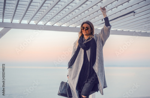 Portrait of woman wearing winter coat and sunglasses looking away, Odessa, Odeska Oblast, Ukraine photo