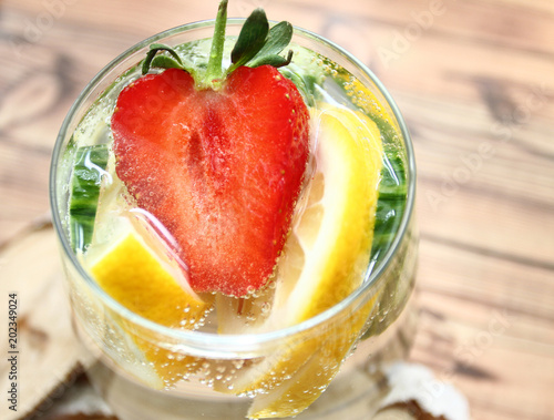 Detox flavored water with lemon  cucumber and  strawberry on white background with decoration. Healthy food concept.  Refreshing summer homemade cocktail. Copy space. No sharpen. 