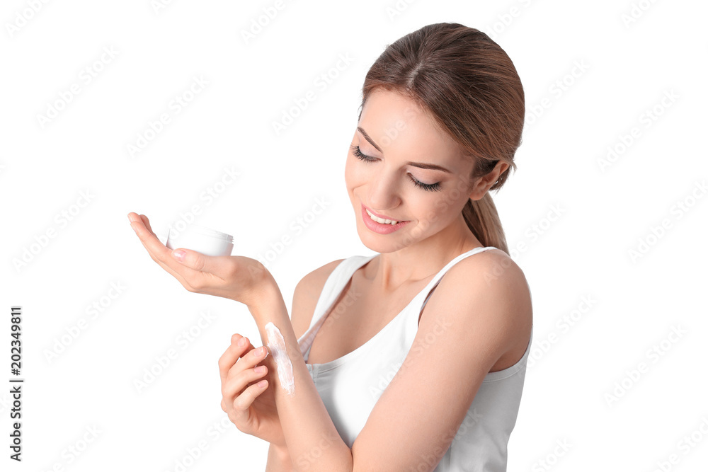 Young woman applying hand cream on white background Young woman applying hand cream on white background