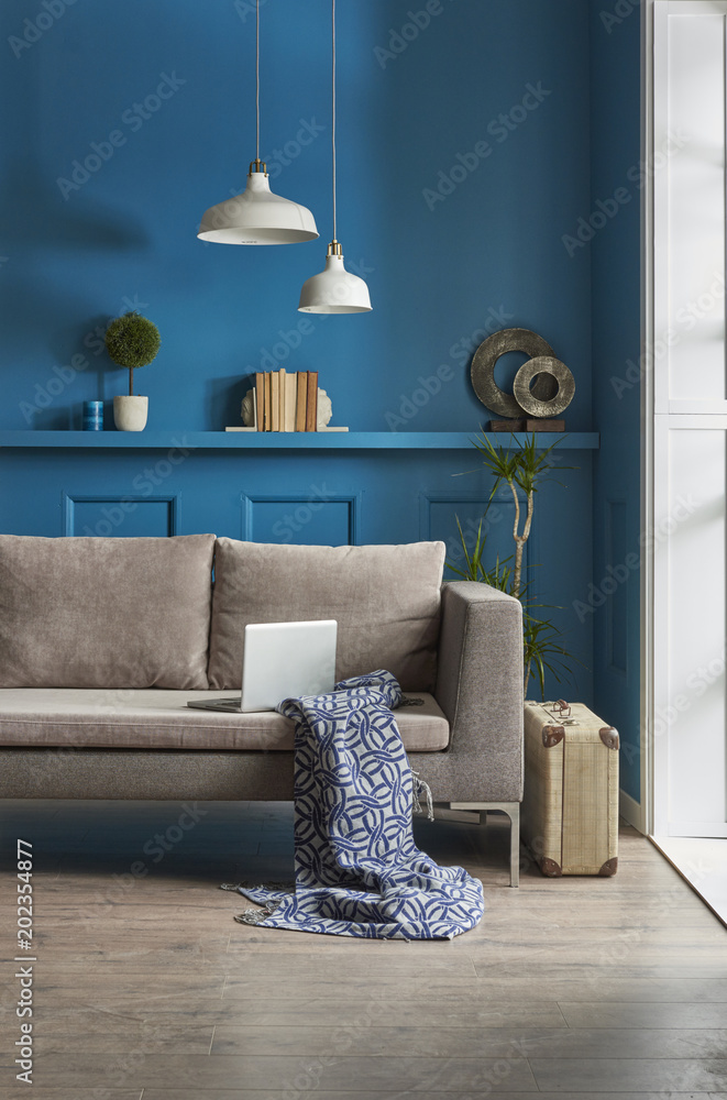 blue wall grey sofa interior decoration. Stock Photo Adobe Stock