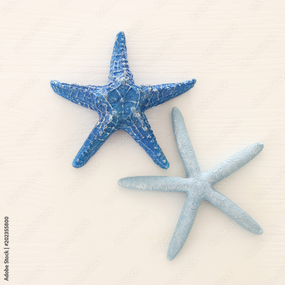 vacation and summer image with starfish over white wooden background. vacation and summer image with starfish over white wooden background.