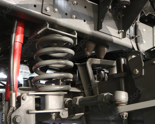 Watering machine. Gray suspension spring with shock absorber.