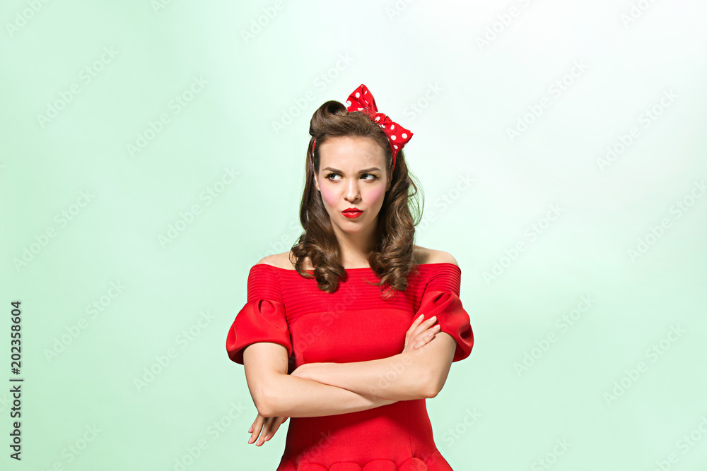Beautiful young woman with pinup make-up and hairstyle. Studio shot on white background Beautiful young woman with pinup make-up and hairstyle. Studio shot on white background