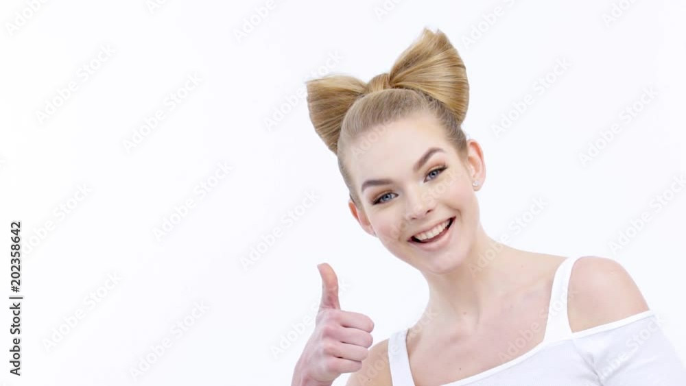 Attractive smiling girl peeps out and shows thumbs up Attractive smiling girl peeps out and shows thumbs up