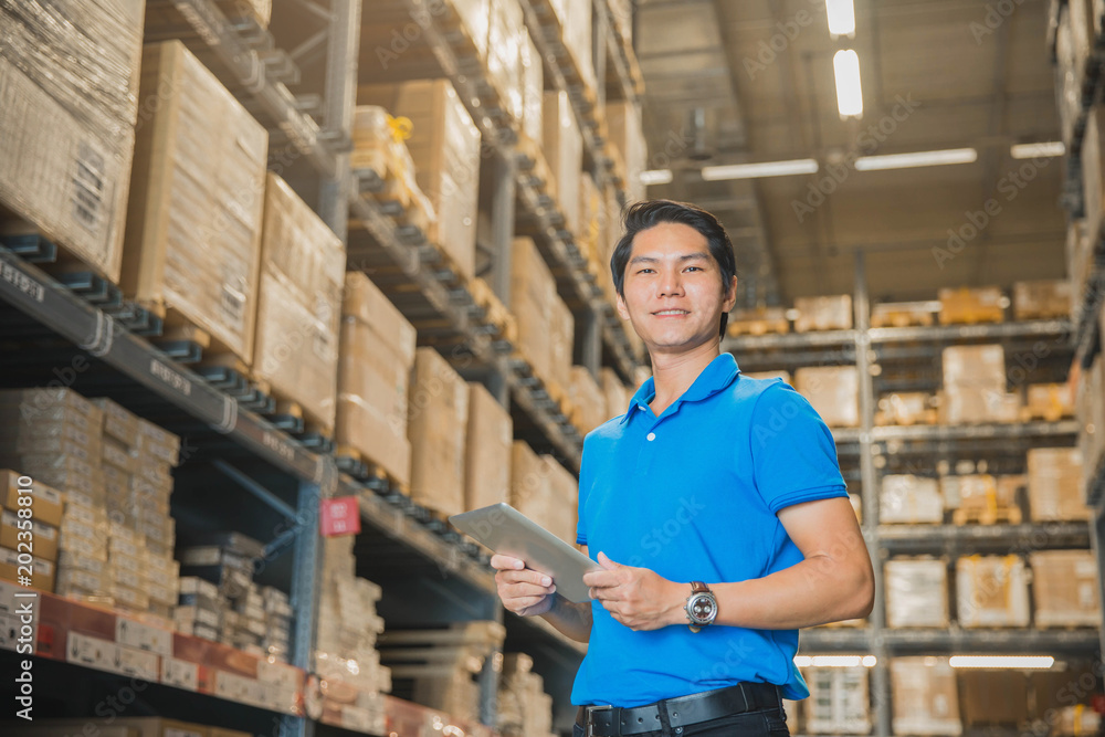 Portrait Of Manager In Warehouse. wholesale, logistic, people and export concept . Business owner Using Tablet Computer In Distribution Warehouse. Portrait Of Manager In Warehouse. wholesale, logistic, people and export concept . Business owner Using Tablet Computer In Distribution Warehouse.