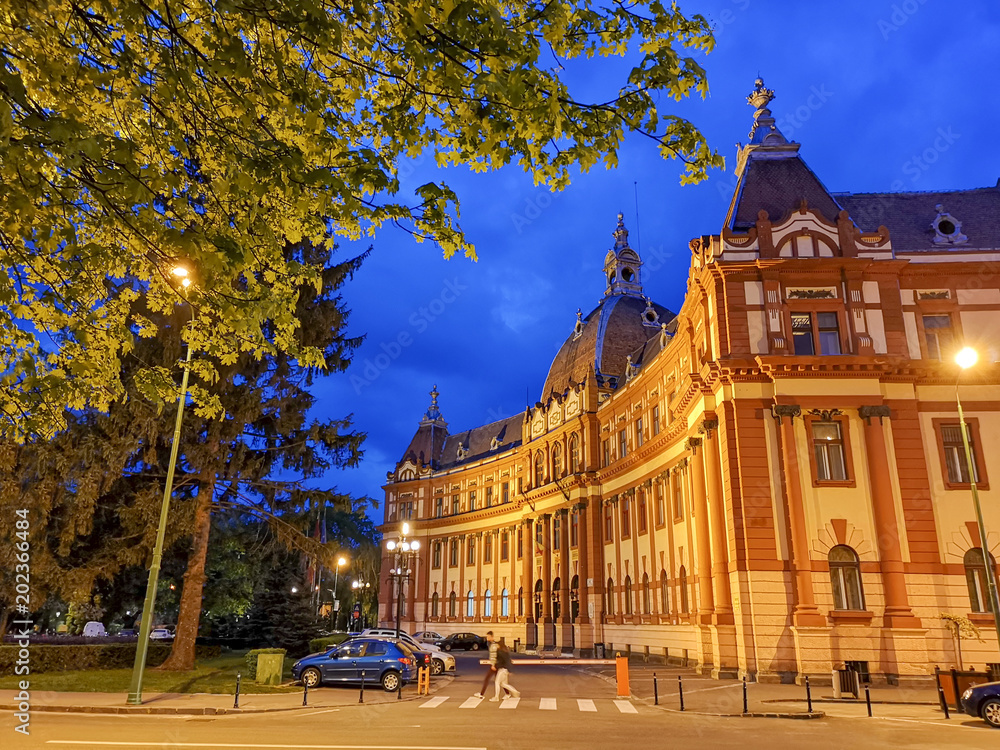 Town Hall architecture in Brasov city, illuminated at dusk to down in Transylvania - Romania