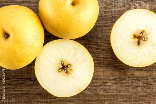 Chinese golden pear collection top view Nashi variety isolated on wooden background. photo