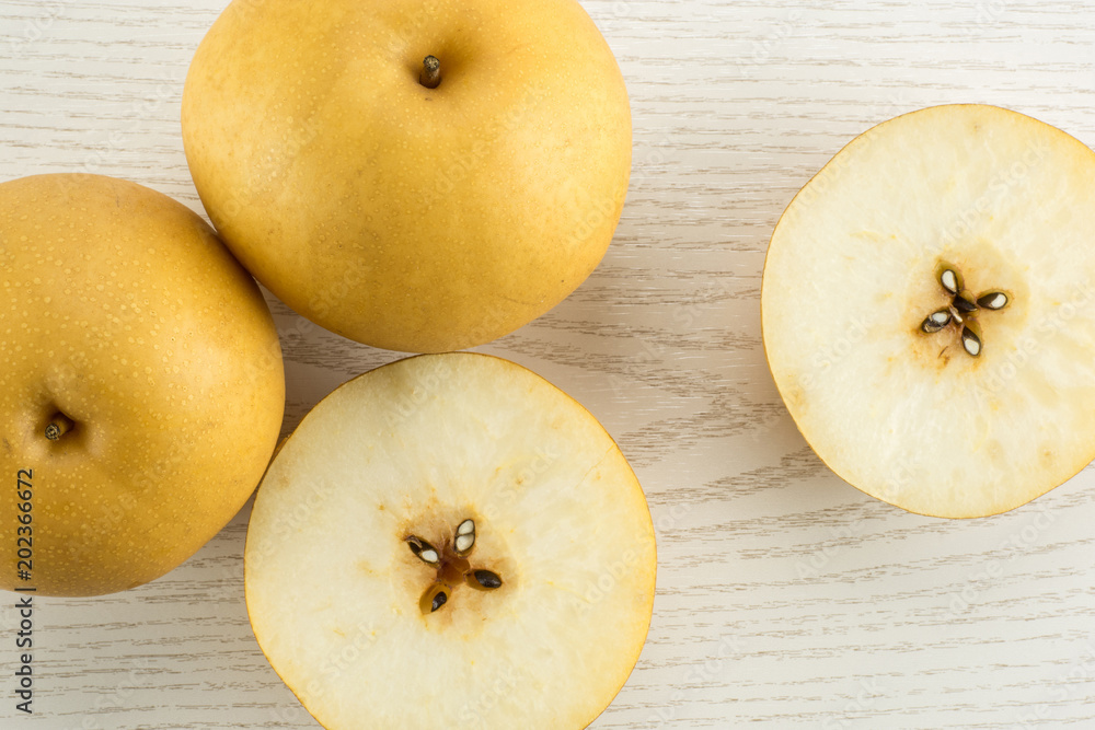 Chinese golden pear collection top view Nashi variety isolated on white wooden background. Chinese golden pear collection top view Nashi variety isolated on white wooden background.