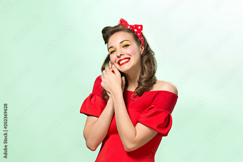 Beautiful young woman with pinup make-up and hairstyle. Studio shot on white background Beautiful young woman with pinup make-up and hairstyle. Studio shot on white background