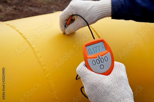 The gas pipeline. Measurement of the thickness of the paint instrument.