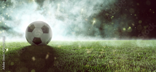Fußball liegt auf Stadionrasen im Rauch © lassedesignen
