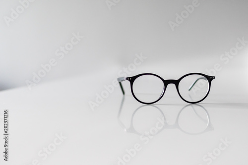 Black Eyeglasses closeup. Eye glasses.Modern style eyeglasses. Round glasses with transparent lenses. Vintage Glasses on white background. Close up eyeglasses with blurry technique.Fashion accessories