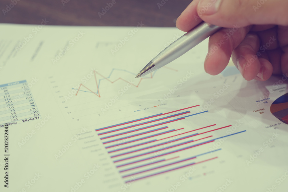 Ταπετσαρία close up man hand use pen for writing on statistic paper , business cocnept