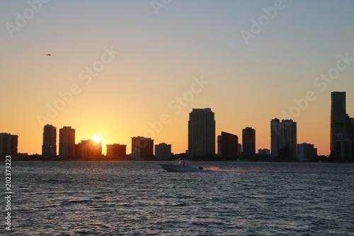 Boat Passing in Front of the Miami Skyline at Sunset in Key Biscayne