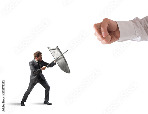 Little business man challenges big problems fighting with shield and sword