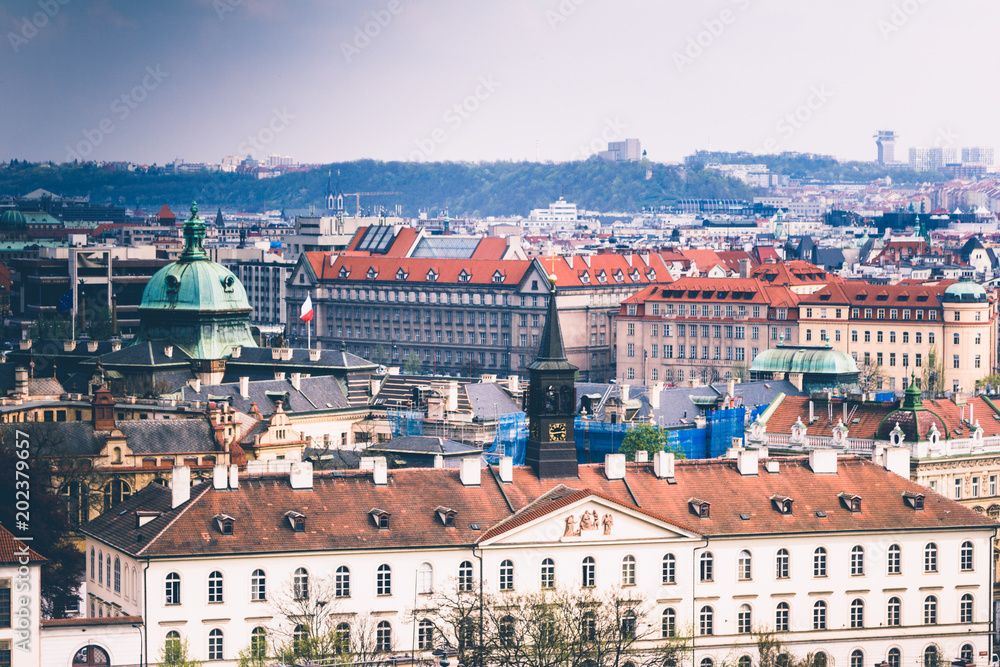 Panoramic view of Prague roofs and domes. Czech Republic. Europe. Filtered image:cross processed retro effect.
