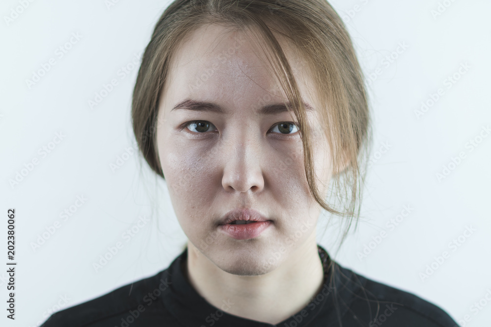 Portrait of serious Asian young woman isolated on white background Portrait of serious Asian young woman isolated on white background