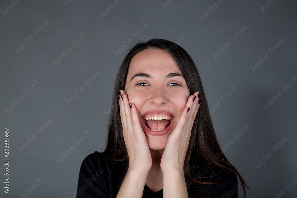 Beautiful young Turkish girl standing very shocked and rejoiced Beautiful young Turkish girl standing very shocked and rejoiced