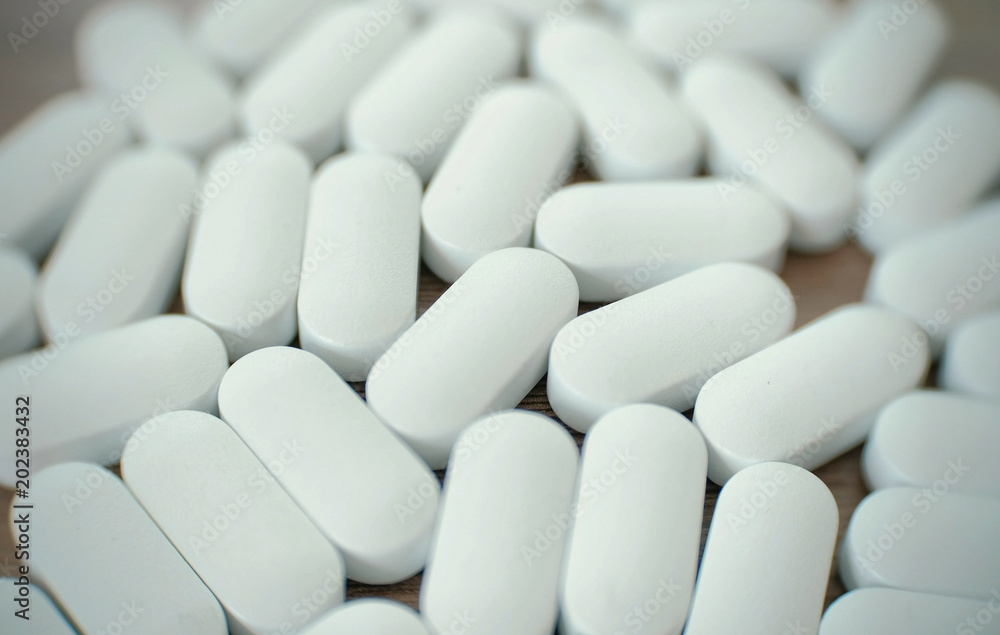 White pills on the table. White pills on the table.