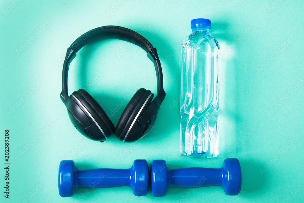 Sport flat lay composition with dumbbells and headphones