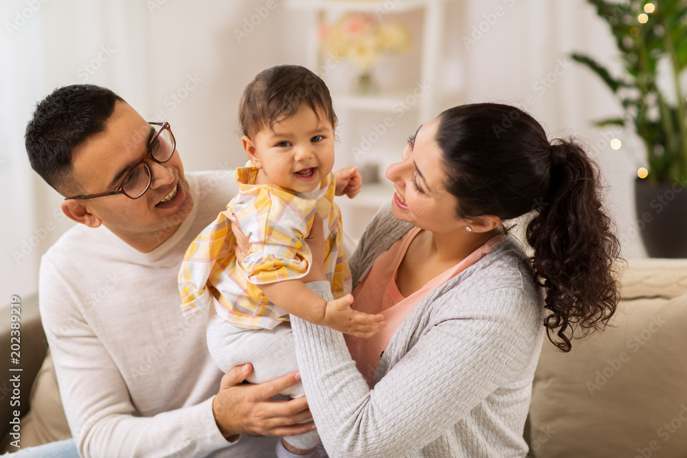 family, parenthood and people concept - happy mother, father with baby daughter at home family, parenthood and people concept - happy mother, father with baby daughter at home