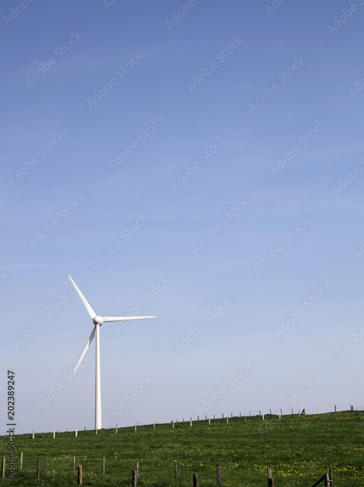 Wind turbine on a green hill with copy space Wind turbine on a green hill with copy space