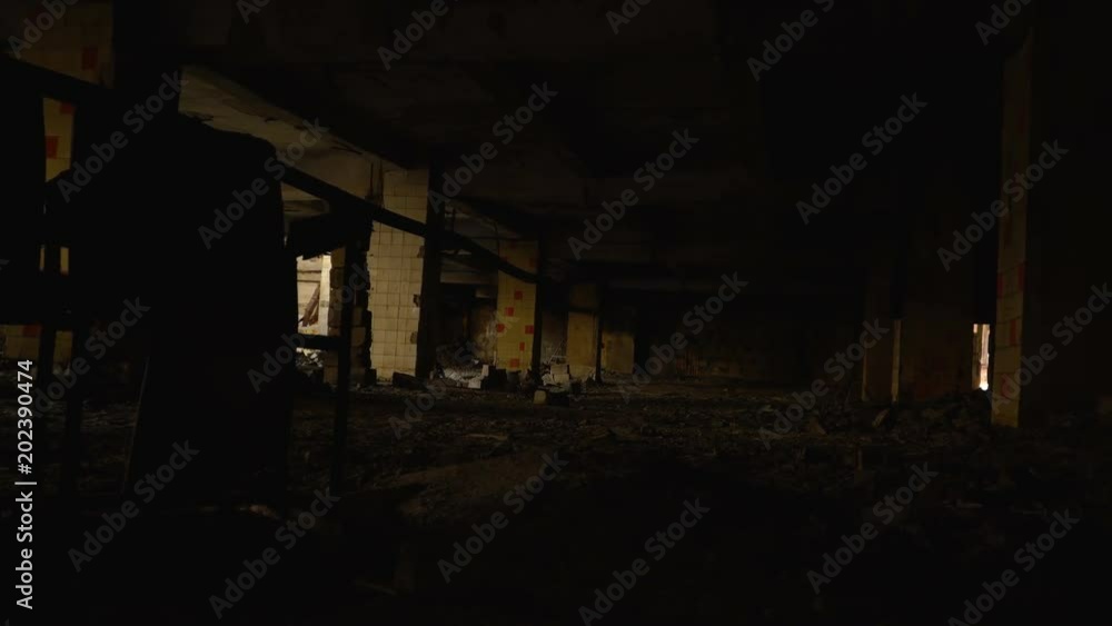 A dark hall with columns of an old abandoned industrial building. A dark hall with columns of an old abandoned industrial building.