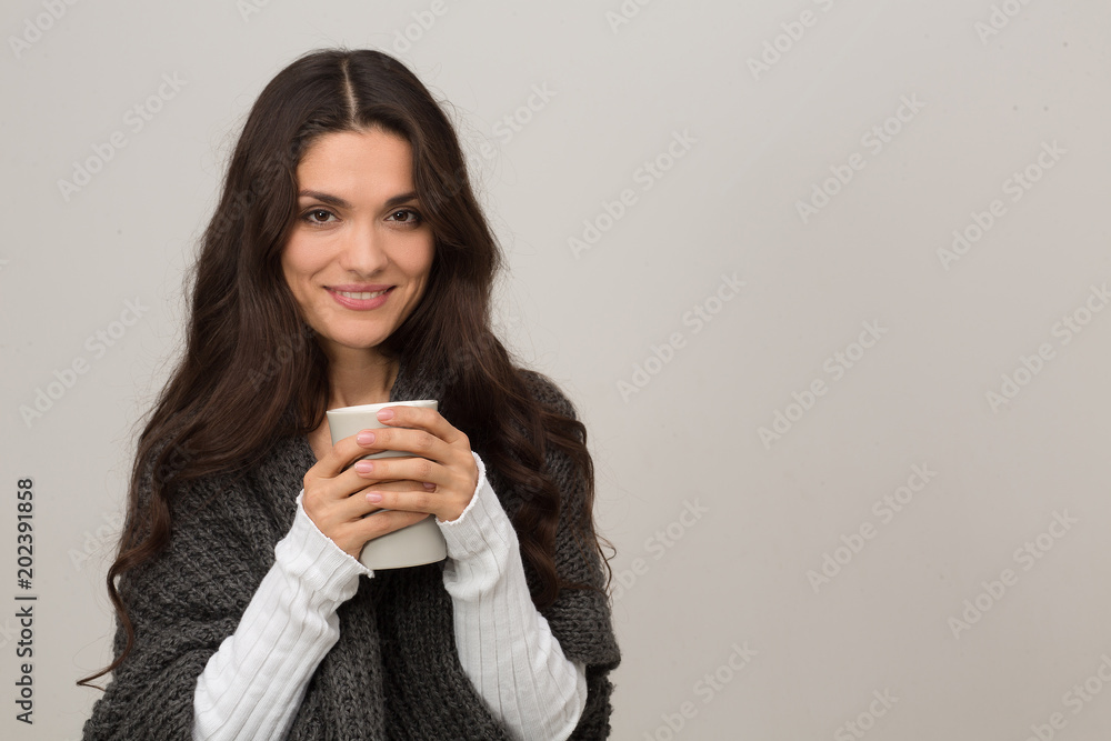 Portrait of brunette in gray cardigan. Having cup of coffee. Isolated on white background. Mid age woman over 35 years old beauty concept. Portrait of brunette in gray cardigan. Having cup of coffee. Isolated on white background. Mid age woman over 35 years old beauty concept.
