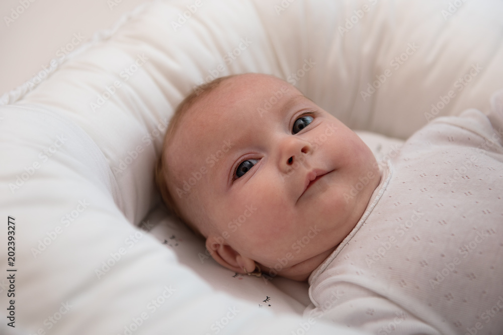 Little baby girl in white interior with blanket using pillow sleeping device Little baby girl in white interior with blanket using pillow sleeping device