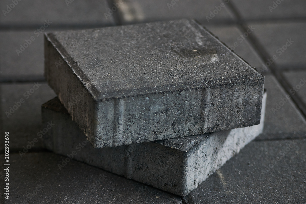 Concrete Paving slabs factory. Tiles piled in pallets, close-up, selective focus. Warehouse paving slabs in the factory for its production Concrete Paving slabs factory. Tiles piled in pallets, close-up, selective focus. Warehouse paving slabs in the factory for its production
