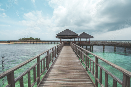 Wooden Pier at Tropical Beach © Hermiadi