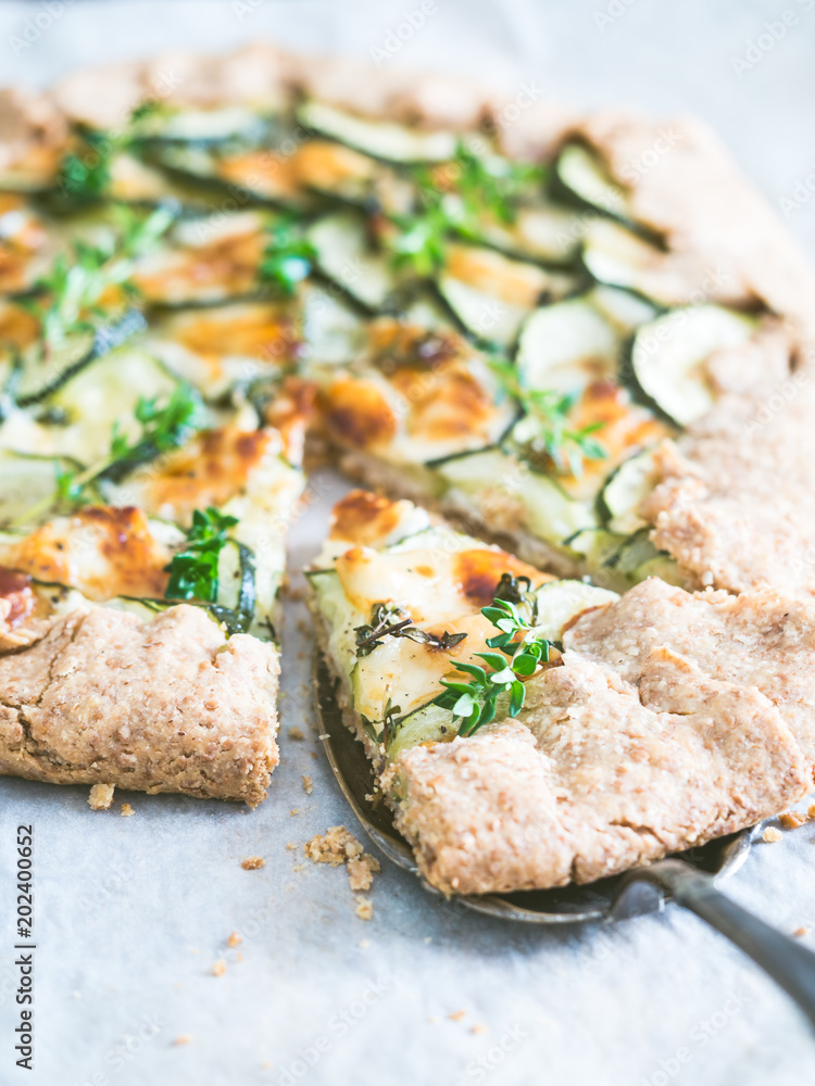 Savory zucchini and cheese galette on spelt dought, served with fresh thyme