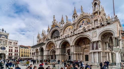 Timelapse of Campanile di San Marco and Palazzo Ducale Doge's Palace in Venice, Italy. Columns of San Marco and San Todaro. Blue cloudy sky at 4K photo