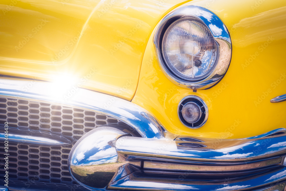 Detail of colorful yellow vintage car headlights