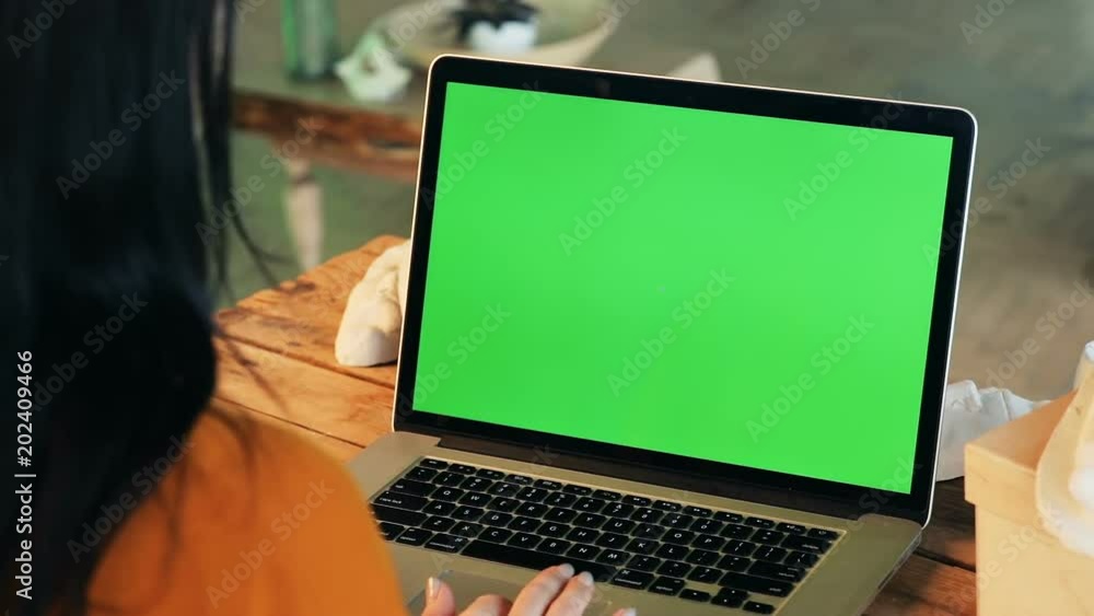 closeup view of woman hands using notebook typing on laptop keyboard with blank green screen copy space for advertising content text mockup chromakey wooden table business lady internet searching closeup view of woman hands using notebook typing on laptop keyboard with blank green screen copy space for advertising content text mockup chromakey wooden table business lady internet searching