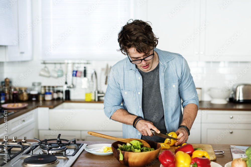 Caucasian man cooking in the kitchen Caucasian man cooking in the kitchen