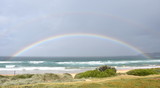 Double rainbow over the Tasman sea. Seascape with beautiful multicoloured rainbow over the sea and Curl Curl beach, Australia.